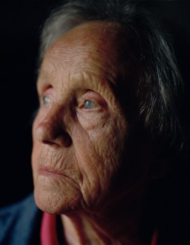 Zgornja Bela, 2023. A portrait of my grandmother looking through the bedroom window. Today, the view from that same window can hold her attention for hours, during which she often becomes unaware of her surroundings.